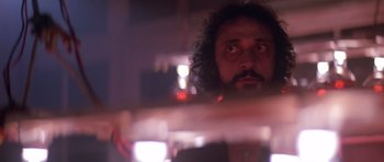 Movie still from “The Star Chamber” (1983), directed by Peter Hyams – A person with curly hair looking at the camera; Close Up shot, Low angle