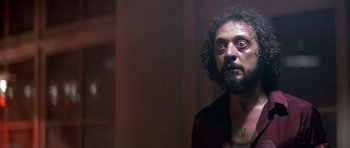 Movie still from “The Star Chamber” (1983), directed by Peter Hyams – A man with a beard is looking at the camera; Close Up shot, Low angle