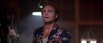 Movie still from “The Star Chamber” (1983), directed by Peter Hyams – A man in a floral shirt looking up at the ceiling; Close Up shot, Low angle