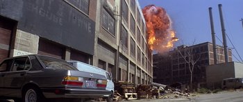Movie still from “The Star Chamber” (1983), directed by Peter Hyams – A building that has a large explosion in the background; Extreme Wide shot, Low angle