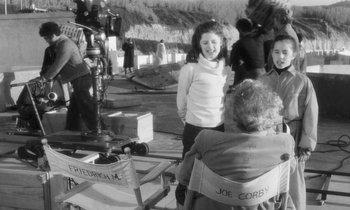 Movie still from “The State of Things” (1982), directed by Wim Wenders – A black and white photo of a girl and two older women; Medium shot, Over the shoulder angle