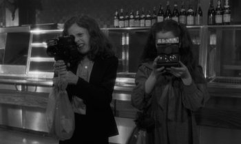 Movie still from “The State of Things” (1982), directed by Wim Wenders – Two women are taking pictures with a video camera; Medium shot, Over the shoulder angle