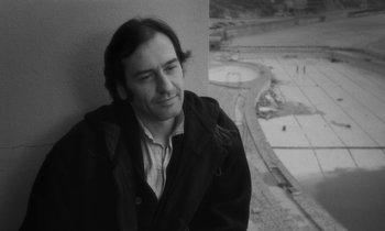 Movie still from “The State of Things” (1982), directed by Wim Wenders – Black and white photograph of a man looking out of a window; Close Up shot, High angle