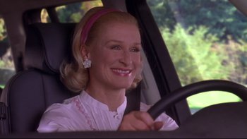 Movie still from “The Stepford Wives” (2004), directed by Frank Oz – A woman sitting in the driver's seat of a car; Close Up shot, Low angle