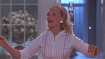 Movie still from “The Stepford Wives” (2004), directed by Frank Oz – A woman with blonde hair wearing a white shirt and a pink headband; Close Up shot, Low angle