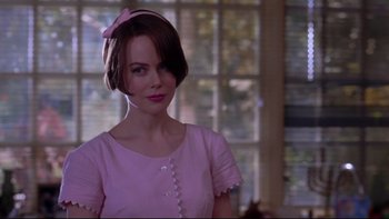 Movie still from “The Stepford Wives” (2004), directed by Frank Oz – A woman in a pink shirt and a pink bow; Close Up shot, Over the shoulder angle