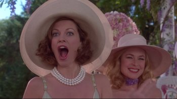 Movie still from “The Stepford Wives” (2004), directed by Frank Oz – Two women wearing hats and one of them has her mouth open; Close Up shot, Low angle