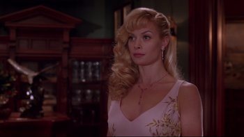 Movie still from “The Stepford Wives” (2004), directed by Frank Oz – A woman with long blonde hair wearing a pink dress; Close Up shot, Over the shoulder angle