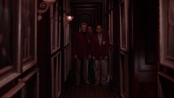 Movie still from “The Stepford Wives” (2004), directed by Frank Oz – A group of men standing next to each other in a hallway; Wide shot, Low angle