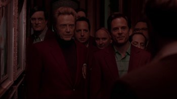 Movie still from “The Stepford Wives” (2004), directed by Frank Oz – A group of men in red jackets standing next to each other; Medium shot, Over the shoulder angle