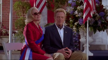 Movie still from “The Stepford Wives” (2004), directed by Frank Oz – A man and a woman sitting next to each other on a porch; Medium shot, Low angle