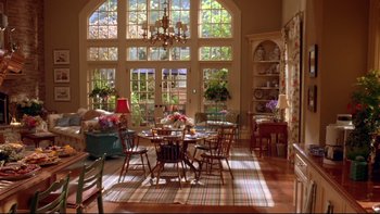 Movie still from “The Stepford Wives” (2004), directed by Frank Oz – A living room filled with lots of furniture and large windows; Extreme Wide shot, High angle
