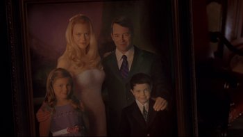 Movie still from “The Stepford Wives” (2004), directed by Frank Oz – A picture of a man , woman , and two young children; Medium shot, High angle