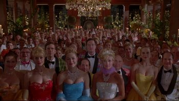 Movie still from “The Stepford Wives” (2004), directed by Frank Oz – A large group of people in formal wear and accessories; Wide shot, Low angle