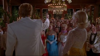 Movie still from “The Stepford Wives” (2004), directed by Frank Oz – A group of people dressed in formal attire; Wide shot, Over the shoulder angle