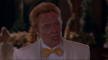 Movie still from “The Stepford Wives” (2004), directed by Frank Oz – A person wearing a suit and a yellow bow tie; Close Up shot, Low angle