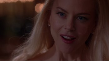 Movie still from “The Stepford Wives” (2004), directed by Frank Oz – A woman's face with a blurry background; Close Up shot, Over the shoulder angle