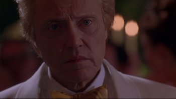 Movie still from “The Stepford Wives” (2004), directed by Frank Oz – An older man with a yellow bow tie looking at the camera; Close Up shot, Low angle