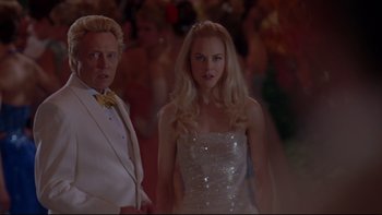 Movie still from “The Stepford Wives” (2004), directed by Frank Oz – A man and a woman are walking in a crowd of people; Close Up shot, Low angle