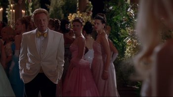 Movie still from “The Stepford Wives” (2004), directed by Frank Oz – A group of people in formal wear standing next to each other; Medium shot, Over the shoulder angle