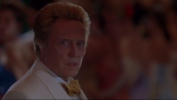 Movie still from “The Stepford Wives” (2004), directed by Frank Oz – A person wearing a suit and bow tie; Close Up shot, Low angle