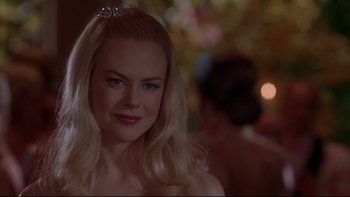 Movie still from “The Stepford Wives” (2004), directed by Frank Oz – A woman with long blonde hair wearing a tiara; Close Up shot, Over the shoulder angle