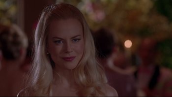 Movie still from “The Stepford Wives” (2004), directed by Frank Oz – A woman with long blonde hair wearing a tiara; Close Up shot, Over the shoulder angle