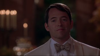 Movie still from “The Stepford Wives” (2004), directed by Frank Oz – A person wearing a suit and bow tie; Close Up shot, Over the shoulder angle