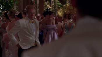 Movie still from “The Stepford Wives” (2004), directed by Frank Oz – A group of people dressed in formal attire; Medium shot, Over the shoulder angle