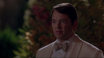 Movie still from “The Stepford Wives” (2004), directed by Frank Oz – A man in a suit and bow tie looking to his left; Close Up shot, Over the shoulder angle