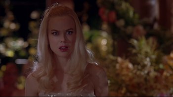Movie still from “The Stepford Wives” (2004), directed by Frank Oz – A woman with blonde hair wearing a tiara; Close Up shot, Over the shoulder angle