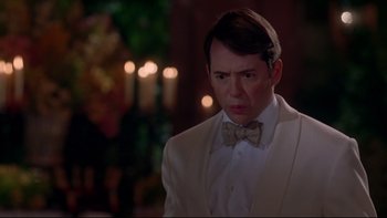 Movie still from “The Stepford Wives” (2004), directed by Frank Oz – A man in a white suit and a bow tie; Close Up shot, Over the shoulder angle