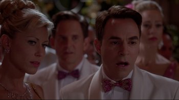 Movie still from “The Stepford Wives” (2004), directed by Frank Oz – A group of people wearing suits and bow ties; Close Up shot, Over the shoulder angle