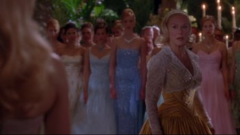 Movie still from “The Stepford Wives” (2004), directed by Frank Oz – A group of women in long dresses in a line; Medium shot, Over the shoulder angle