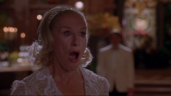 Movie still from “The Stepford Wives” (2004), directed by Frank Oz – A woman in a white dress with a surprised look on her face; Close Up shot, Low angle