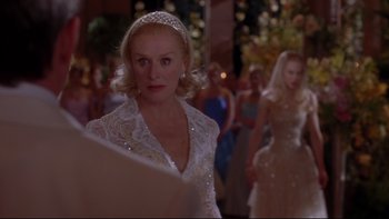 Movie still from “The Stepford Wives” (2004), directed by Frank Oz – A woman wearing a tiara and a white dress; Close Up shot, Over the shoulder angle