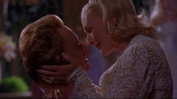 Movie still from “The Stepford Wives” (2004), directed by Frank Oz – A man and a woman are kissing each other; Close Up shot, Low angle