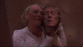 Movie still from “The Stepford Wives” (2004), directed by Frank Oz – A woman and a man are posing for a picture; Close Up shot, Overhead angle