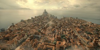 Movie still from “House of the Dragon” (2022), created by George R.R. Martin – An aerial view of a city with a castle in the background; Extreme Wide shot, High angle