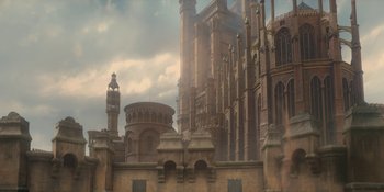 Movie still from “House of the Dragon” (2022), created by George R.R. Martin – An image of an old building with a clock tower in the background; Extreme Wide shot, Low angle