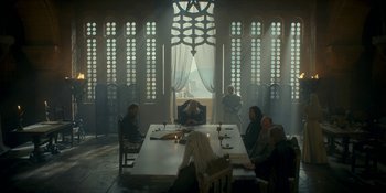 Movie still from “House of the Dragon” (2022), created by George R.R. Martin – A group of people sitting around a white table; Wide shot, Low angle