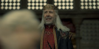 Movie still from “House of the Dragon” (2022), created by George R.R. Martin – A man with a long white beard wearing a crown; Close Up shot, Over the shoulder angle