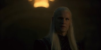 Movie still from “House of the Dragon” (2022), created by George R.R. Martin – A man with long white hair is looking at the camera; Close Up shot, Over the shoulder angle