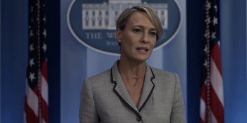 Movie still from “House of Cards” (2013), created by Beau Willimon – A person wearing a suit and tie; Close Up shot, Over the shoulder angle