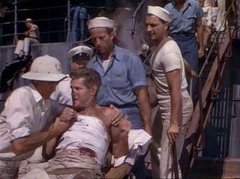 Movie still from “The Story of Dr. Wassell” (1944), directed by Cecil B. DeMille – A group of men on a boat in the water; Wide shot, High angle