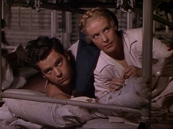 Movie still from “The Story of Dr. Wassell” (1944), directed by Cecil B. DeMille – A man and a woman laying on a bed; Medium shot, High angle