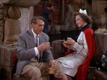 Movie still from “The Story of Dr. Wassell” (1944), directed by Cecil B. DeMille – A man and a woman sitting next to each other; Medium shot, High angle