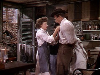 Movie still from “The Story of Dr. Wassell” (1944), directed by Cecil B. DeMille – A man and a woman in a kitchen; Medium shot, Over the shoulder angle