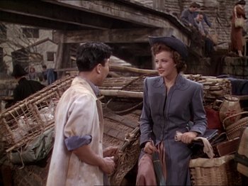 Movie still from “The Story of Dr. Wassell” (1944), directed by Cecil B. DeMille – A man and a woman talking to each other; Medium shot, High angle