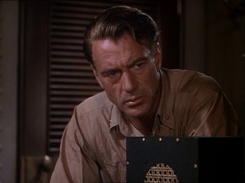 Movie still from “The Story of Dr. Wassell” (1944), directed by Cecil B. DeMille – A person sitting in front of a computer screen; Close Up shot, Low angle